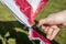 Man cuts scissors finger hand on wedding - tradition cutout heart detail closeup