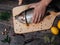 Man cuts a trout with a knife on a Board. Fresh raw fish