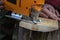 Man cuts wood products, using electric jigsaws outdoors. Close-up