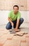 Man cutting ceramic floor tiles