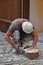 Man cutting ceramic tile with angle grinder