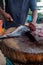 Man cutting fresh tuna with huge knife in Weligama In Sri Lanka.