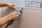 Man cutting gypsum drywall on using angle hand electric power tools