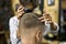 Man is cutting his hair in asian barbershop