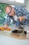 Man cutting laminate board with jigsaw