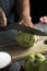 Man cutting a quince fruit with a knife