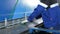 Man cutting sheet metal in large hydraulic guillotine shears. Work at the factory makes several cuts parts.