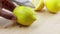 Man, cutting in slice a yellow lemon with knife on the wood chopping board in the kitchen, health and nutrition