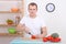 Man cutting tomato in the kitchen