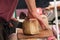 man cutting traditional cheese at the market