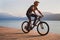 Man cycling on bicycle near beautiful mountain lake, leisure biking