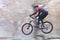 Man cycling fast with mountainbike in a forest in fall