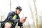 Man in cycling helmet with bicycle using smartphone in park