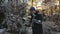 Man cyclist brushes his bicycle in the backyard in winter before taking it into the parking garage. Winter cycling and