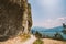 Man cyclist on a mountain bike riding on a gravel bike route at a height near the Lago di Garda in summer in Italy