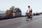 Man cyclist pedaling on a road bike outdoors in sun set