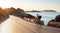 Man cyclist pedaling on a road bike outdoors in sun set