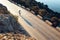 Man cyclist pedaling on a road bike outdoors in sun set