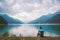 Man cyclist rests near a mountain lake Lago di Ledro in italy