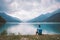 Man cyclist rests near a mountain lake Lago di Ledro in italy