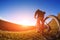 man cyclist stand with mountain bike at sunset