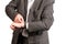 A man in a dark gray suit adjusts his watch