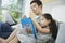 Man And Daughter With Picture Book And Newspaper