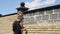 Man decorates the facade of the fence with decorative torn bricks. Work at home during quarantine. DIY