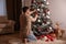 Man decorating beautiful Christmas tree at home