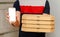 Man from delivery service holding pizza boxes and smartphone with mock up.