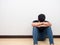 Man depressed sit on floor white wall background touch his head feeling sad,Asian man wearing mask sit on floor afraid emotion