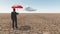 Man in desert with umbrella