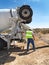 Man in Desert Working with Cement Truck - Vertical