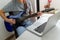 Man at a desk at home taking electric guitar internet classes