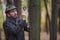 Man detective with a beard examines a tree trunk