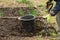 A man is digging a shovel soil in the garden