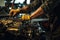 A man diligently repairing an automobile engine inside a garage