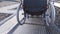 A man with disabilities moves along the street in a wheelchair