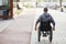 Man with disability riding in wheelchair in the city