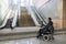 Man with disability on wheelchair stopped in front of staircase