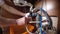 A man disassembles the plumbing under the sink for cleaning and maintenance