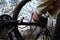 A man dismantles the rear wheel of a bicycle