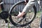 A man dismantles the rear wheel of a bicycle