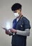 Man, doctor and digital tablet for global communication or healthcare research with covid mask. Male medical expert on