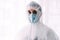 Man doctor or scientist wearing protective suit, and face mask
