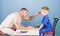 Man doctor sit table medical tools examining little boy patient. Health care. Pediatrician concept. Child care. Careful