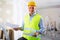 Man with documents in her hands stands in the middle of renovated room in cottage