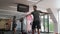 A man does intense exercises with a kettlebell in a gymnastics gym. Swinging the weight forward and up.