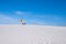 Man does a trick on the snowboard in the desert