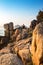 A Man Does Yoga on Boulders in The Morning Sunshine